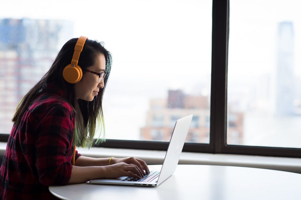 Image of a woman working at a laptop on paac-it.com